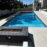 Final product of a foam block pool, featuring a bright blue water and an accent fire place.