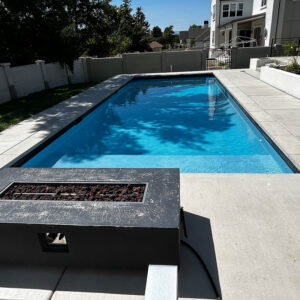 Final product of a foam block pool, featuring a bright blue water and an accent fire place.
