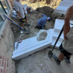 Installing retaining wall at the bottom of walk out stair case.