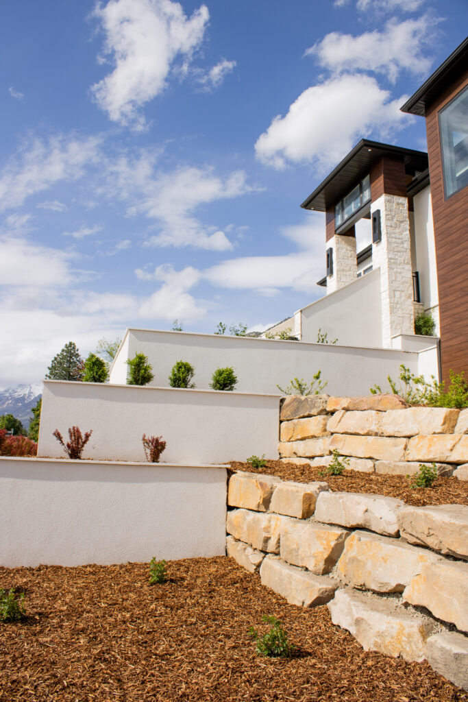 Experience the elegance of our 13-tiered planter bed retaining wall, a highlight of the 2025 Utah Valley Parade of Homes. This design seamlessly combines functionality with aesthetic appeal, enhancing the landscape’s natural beauty.