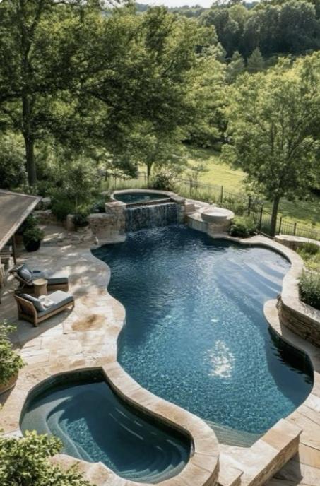 Elegant marble pergola and tiered steps leading to a luxury backyard pool, surrounded by greenery and classical planters